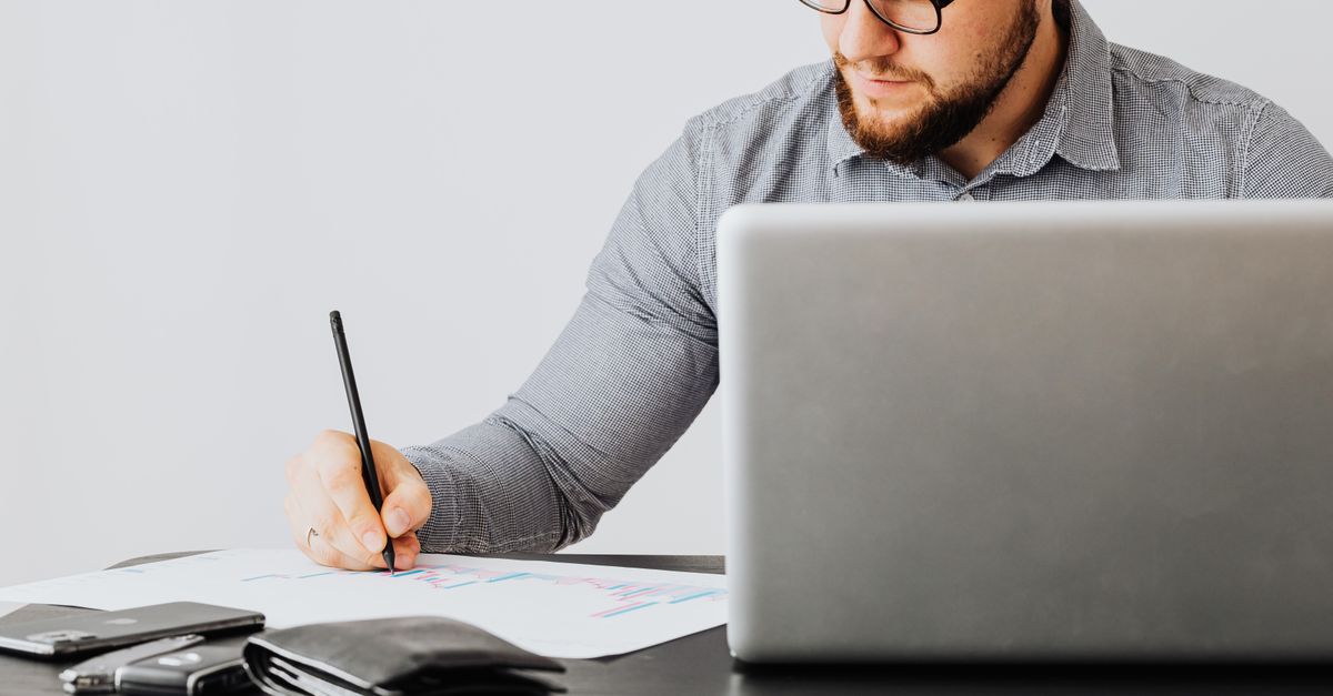 A founder working through company paperwork at a laptop